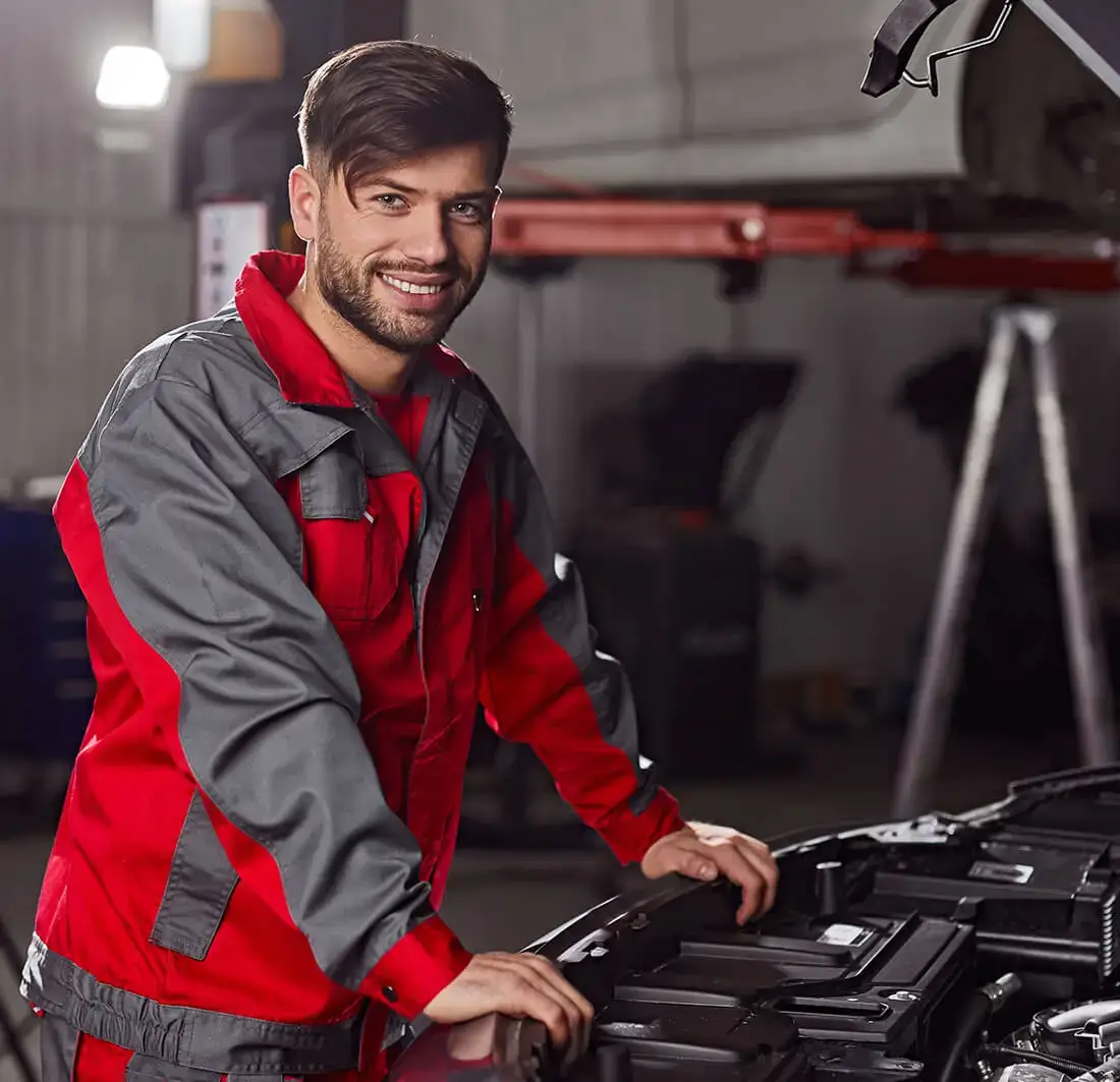 Mechanic working on car engine